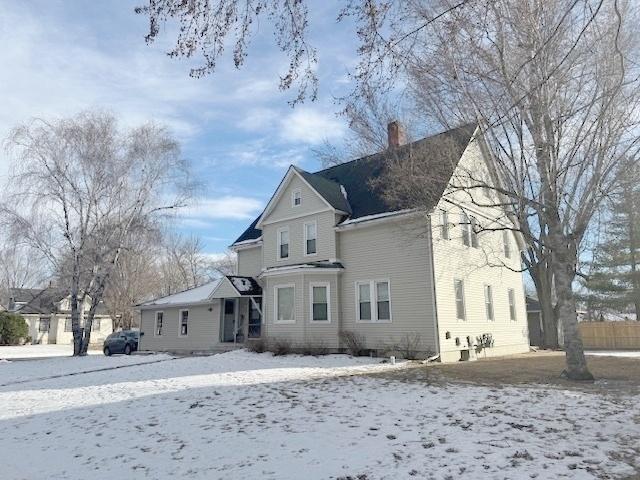 view of snow covered rear of property