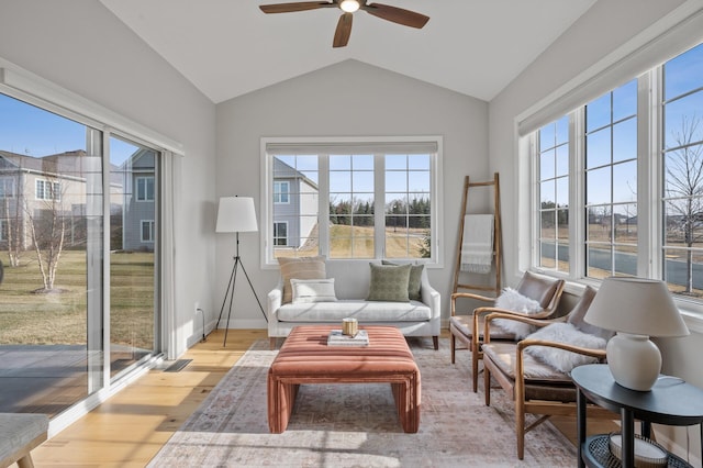 sunroom with ceiling fan and lofted ceiling