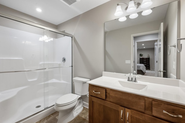 bathroom with vanity, a shower with door, and toilet