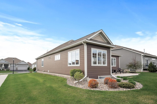 view of home's exterior with a yard, a patio, and a garage