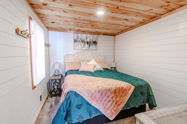 carpeted bedroom with wood walls, multiple windows, and wooden ceiling