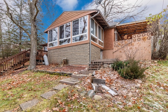 view of home's exterior with a sunroom