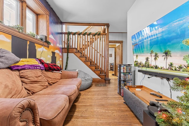 living area featuring stairs and light wood-style floors