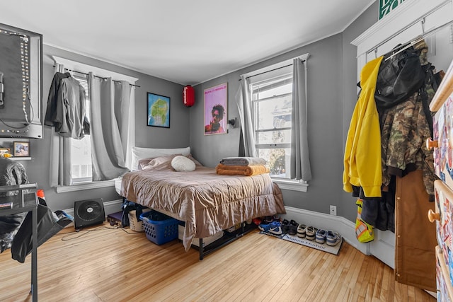 bedroom with light wood-style floors and baseboards