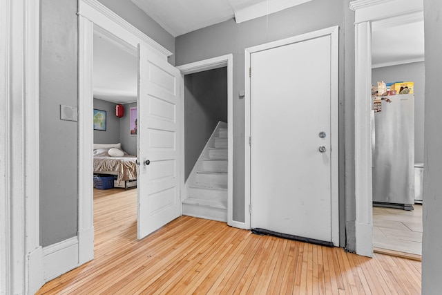 foyer entrance with stairs and wood finished floors