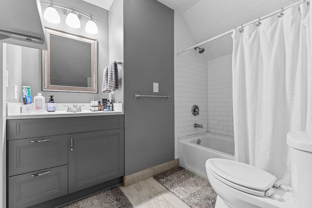 full bathroom with lofted ceiling, toilet, vanity, baseboards, and shower / bath combo with shower curtain