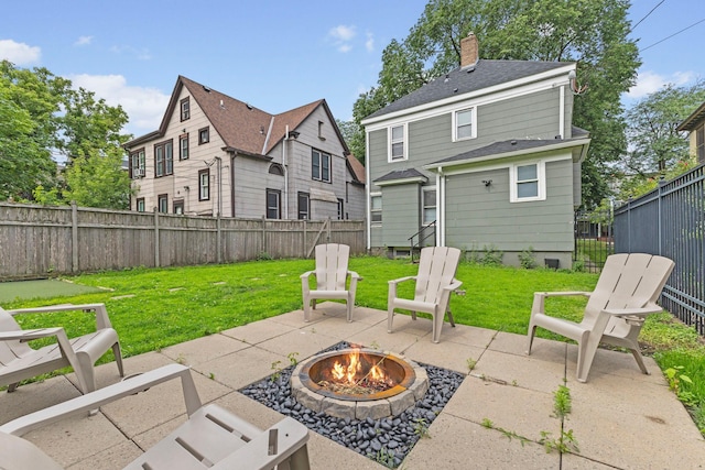 2707 Fremont Ave S, Minneapolis, MN 55408 - fenced backyard with an outdoor fire pit and a patio area