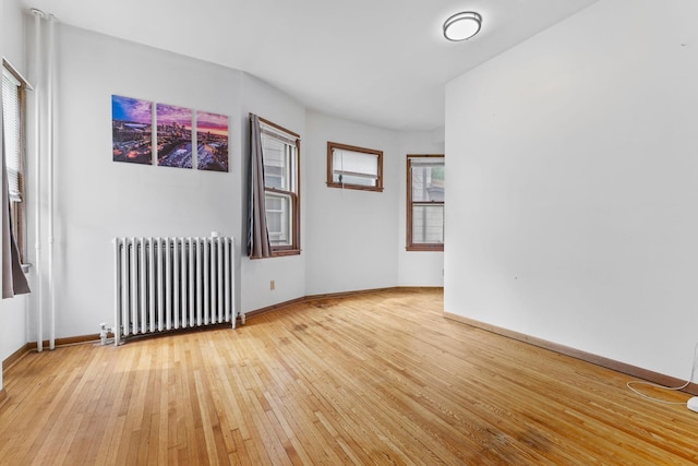2707 Fremont Ave S, Minneapolis, MN 55408 - unfurnished room featuring radiator heating unit and light wood-style floors