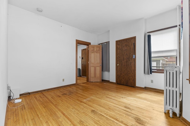 2707 Fremont Ave S, Minneapolis, MN 55408 - unfurnished bedroom with radiator and light wood-type flooring