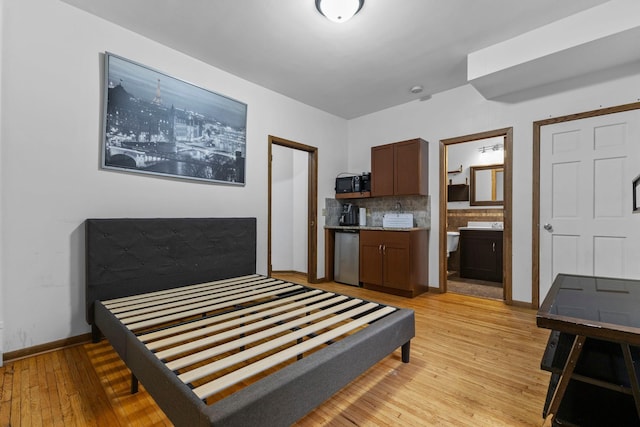 2707 Fremont Ave S, Minneapolis, MN 55408 - bedroom with light wood finished floors and ensuite bath