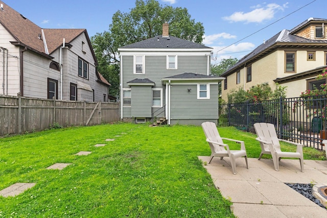 2707 Fremont Ave S, Minneapolis, MN 55408 - rear view of property with a fenced backyard, a chimney, roof with shingles, and a patio