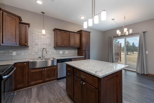 kitchen featuring stainless steel appliances, hanging light fixtures, sink, and light stone counters