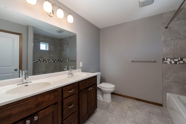 bathroom with vanity, tile patterned floors, and toilet