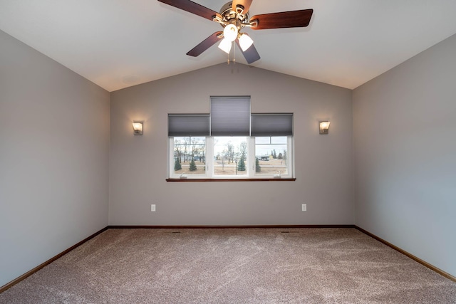 carpeted spare room with lofted ceiling and ceiling fan