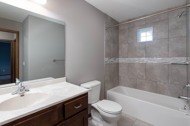 full bathroom with vanity, toilet, tiled shower / bath combo, and tile patterned flooring