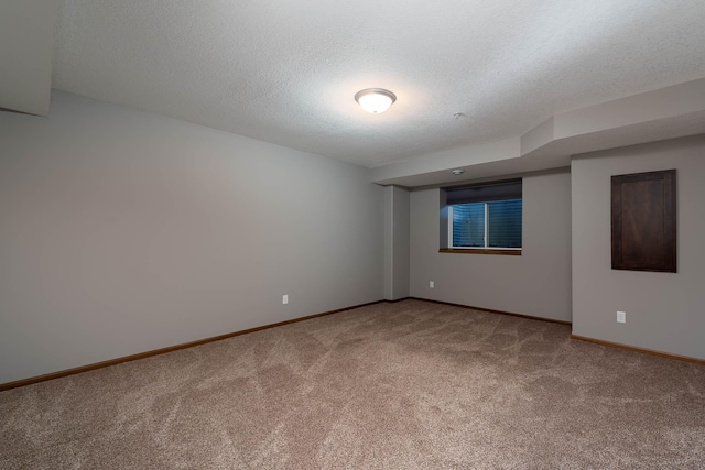 carpeted spare room featuring a textured ceiling