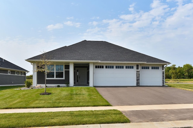 view of front of home featuring a garage and a front yard