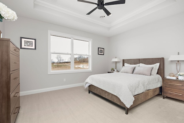 bedroom with crown molding, ceiling fan, and a raised ceiling