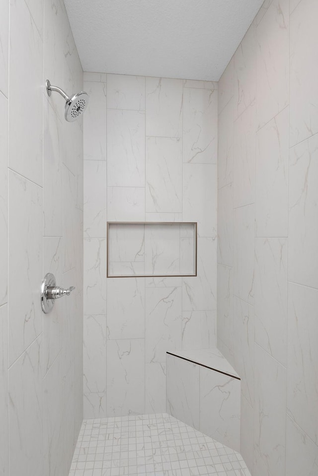 bathroom featuring a tile shower