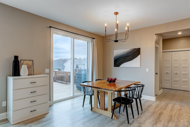 dining area featuring an inviting chandelier and light hardwood / wood-style floors