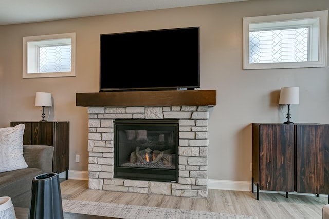 room details featuring hardwood / wood-style flooring and a stone fireplace