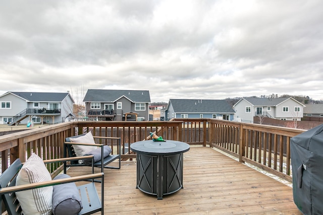 wooden deck with a grill and an outdoor fire pit