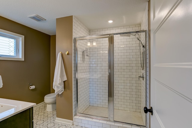 bathroom with vanity, tile patterned floors, toilet, and walk in shower