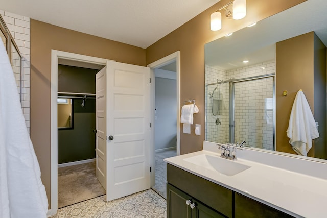 bathroom with an enclosed shower and vanity