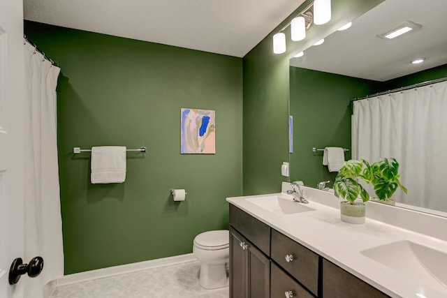 bathroom featuring vanity, tile patterned floors, and toilet