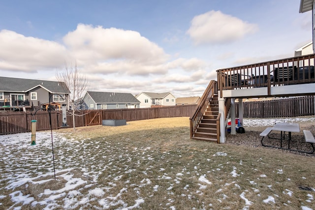 snowy yard with a deck