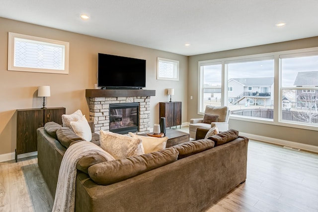 living room with a fireplace and light hardwood / wood-style flooring