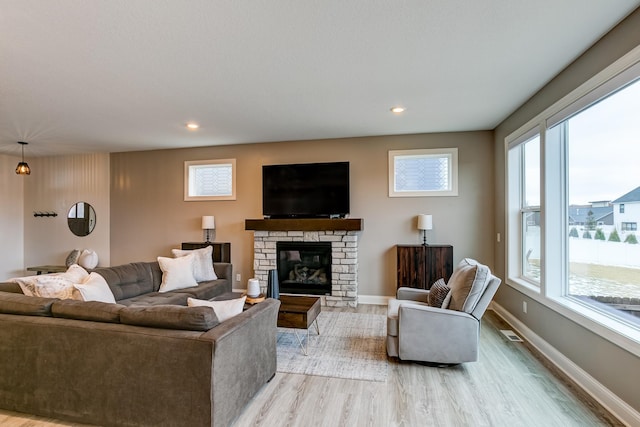 living room featuring a fireplace and light hardwood / wood-style floors