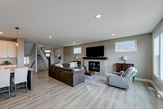 living room featuring light hardwood / wood-style flooring and a fireplace