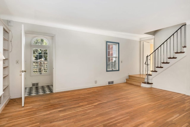 unfurnished living room with wood-type flooring