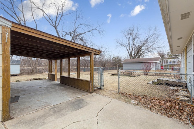 view of patio with an outbuilding and a carport