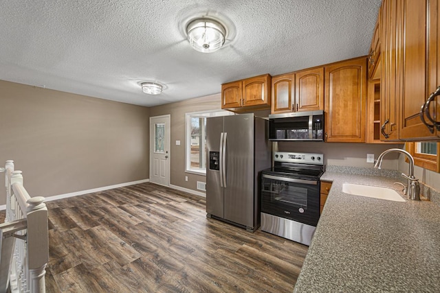 kitchen featuring sink, stainless steel appliances, and dark hardwood / wood-style floors