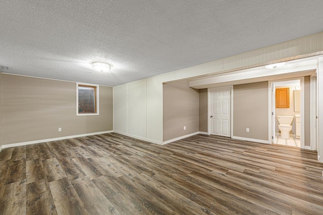 spare room with hardwood / wood-style flooring and a textured ceiling