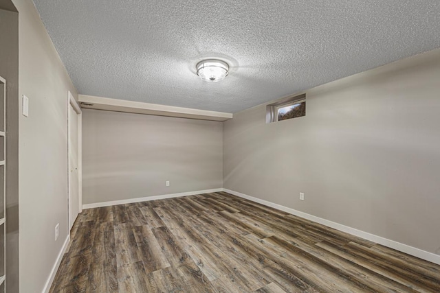 basement with dark hardwood / wood-style floors and a textured ceiling