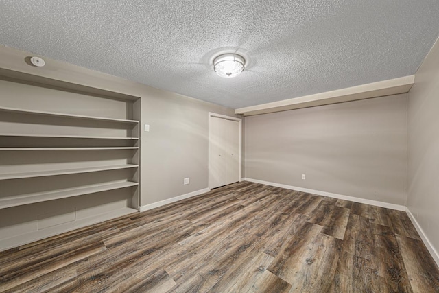 interior space featuring dark wood-type flooring and a textured ceiling