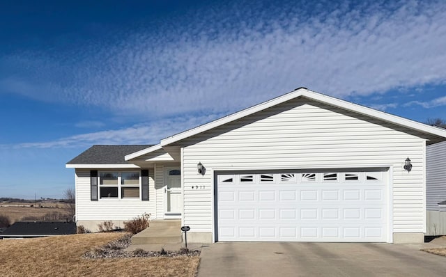 ranch-style house featuring a garage, driveway, and a shingled roof