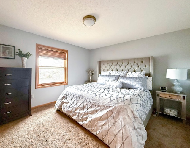 bedroom featuring baseboards, carpet floors, and a textured ceiling