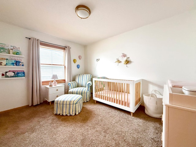 carpeted bedroom featuring a nursery area