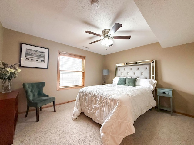 bedroom with visible vents, light carpet, a textured ceiling, baseboards, and ceiling fan