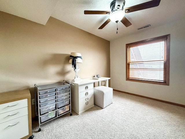 home office with visible vents, light carpet, a ceiling fan, a textured ceiling, and baseboards