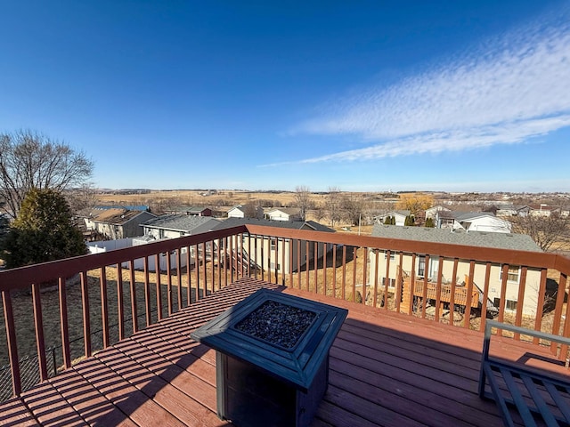 deck with a residential view and an outdoor fire pit