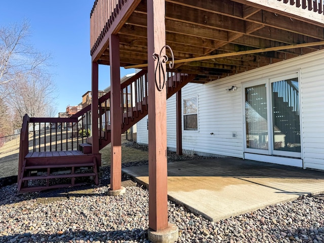 wooden deck with a patio area and stairway