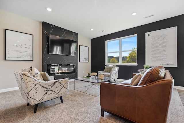 carpeted living room featuring a premium fireplace