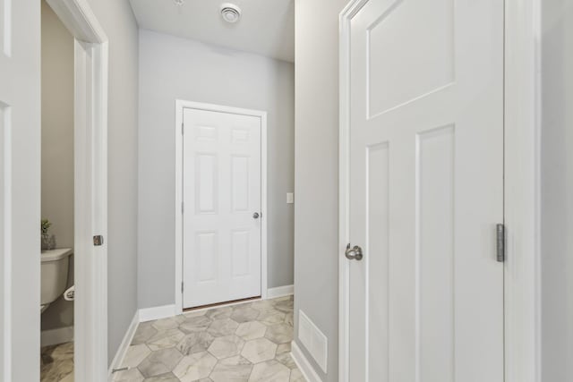 corridor featuring light tile patterned floors