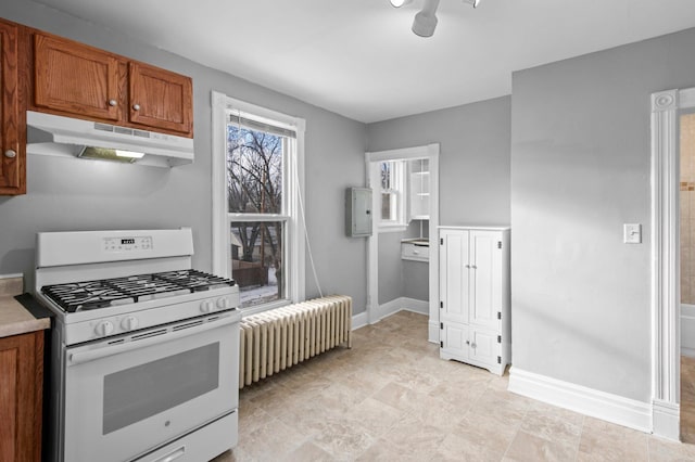 kitchen featuring radiator heating unit and white gas stove