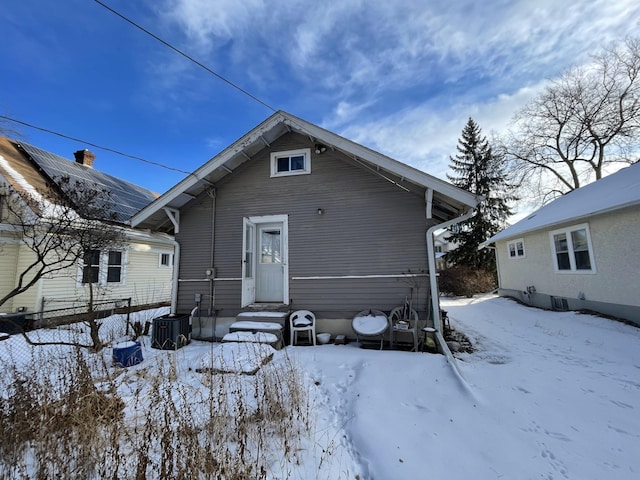 snow covered property featuring central air condition unit